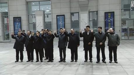Chinese officials wave goodbye as Kim&#39;s train departs Dandong.