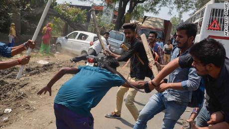 A protester is beaten by Indian students after members of the Dalit community and other &quot;low caste&quot; groups threw bricks at their college during countrywide protests on April 2, 2018 in Meerut in Uttar Pradesh state, India. The protesters opposed a Supreme Court order they felt diluted the rights of members of the lower castes. 