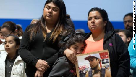 April 9, 2018; Morristown, TN, USA; Esmeralda Baustista holds a photograph of her brother Luis Bautista-Martinez, who was one of the workers detained when ICE raided Southeastern Provisions, a cattle slaughterhouse in Grainger County. With Bautista is daughter Yemaya and friend Yaqueline Cruz. The three attended a prayer vigil at Hillcrest Elementary School in Morristown, TN held in response to the raid. Mandatory Credit: Saul Young/Knoxville News Sentinel via USA TODAY NETWORK/Sipa US