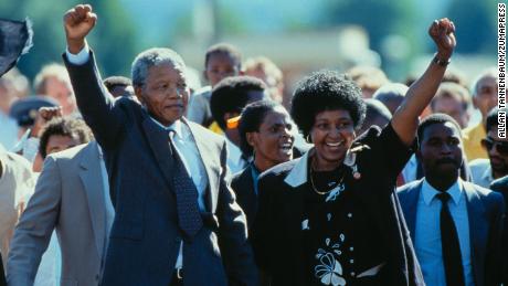 Nelson Mandela with his then-wife, Winnie Mandela, walk out of prison. 