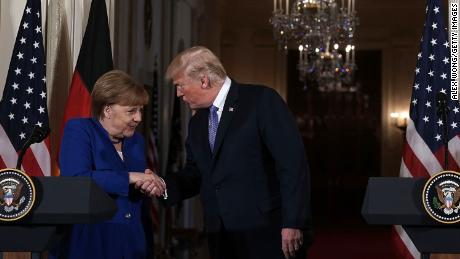 US President Donald Trump shakes hands with German Chancellor Angela Merkel in Washington in April. 