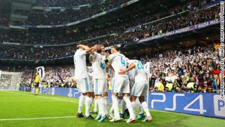 Real Madrid celebrate Benzema&#39;s opening goal.