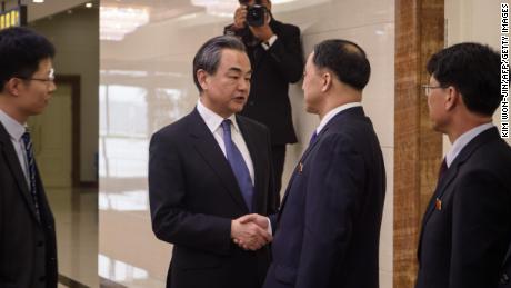 China&#39;s foreign minister Wang Yi (centre L) shakes hands with North Korea&#39;s vice foreign minister Ri Kil Song (centre R) at Pyongyang international airport on May 2.