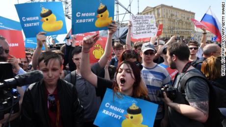Opposition supporters hold placards and shout slogans during Saturday&#39;s anti-Putin rally in Moscow.