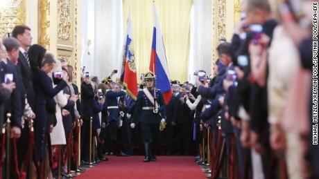 Honour Guards carry the Russian Presidential Standard and Russian National Flag during the  ceremony in the Kremlin.