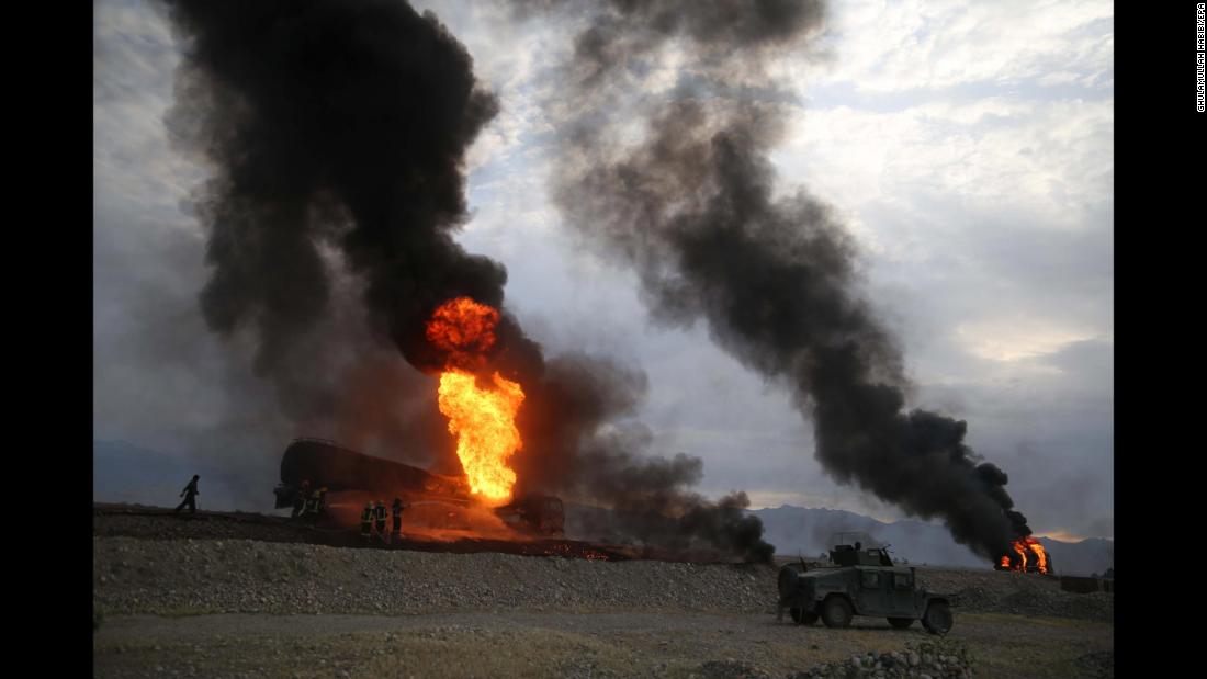 Firefighters work in Afghanistan&#39;s Nangarhar province after oil tankers were allegedly bombed by militants on Saturday, May 5.