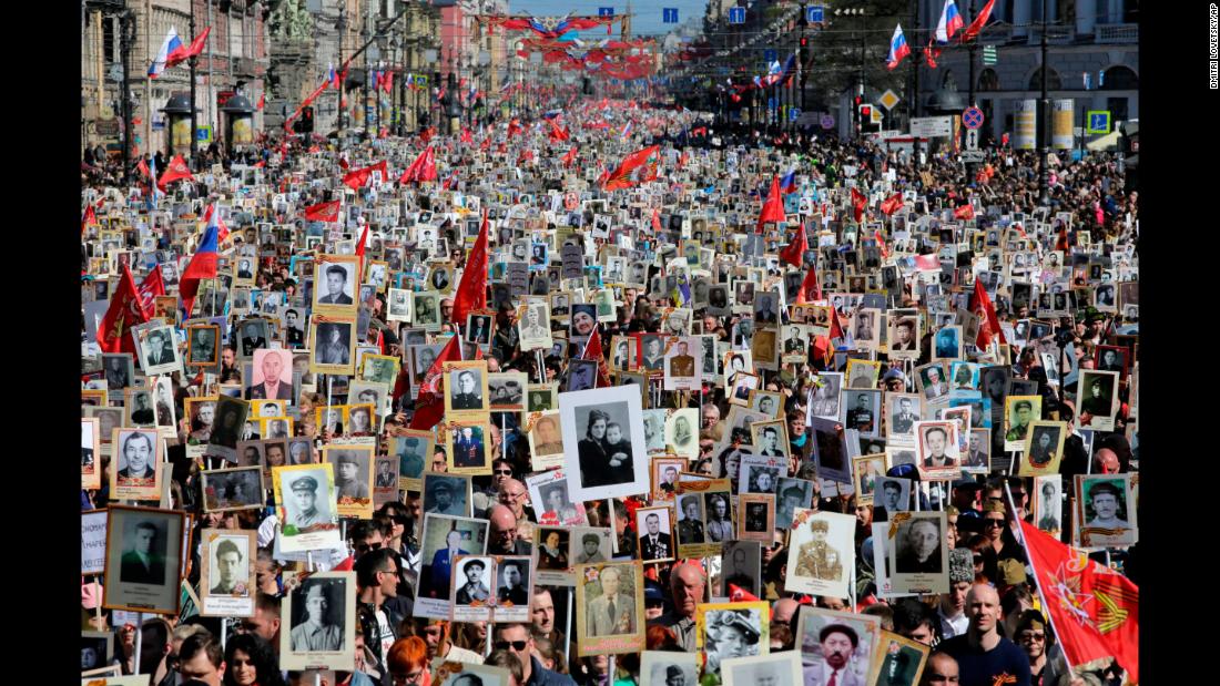 People in St. Petersburg, Russia, carry portraits of their ancestors, World War II veterans, during an &quot;Immortal Regiment&quot; march on Wednesday, May 9. The annual march pays tribute to those who helped defeat the Nazis 73 years ago.