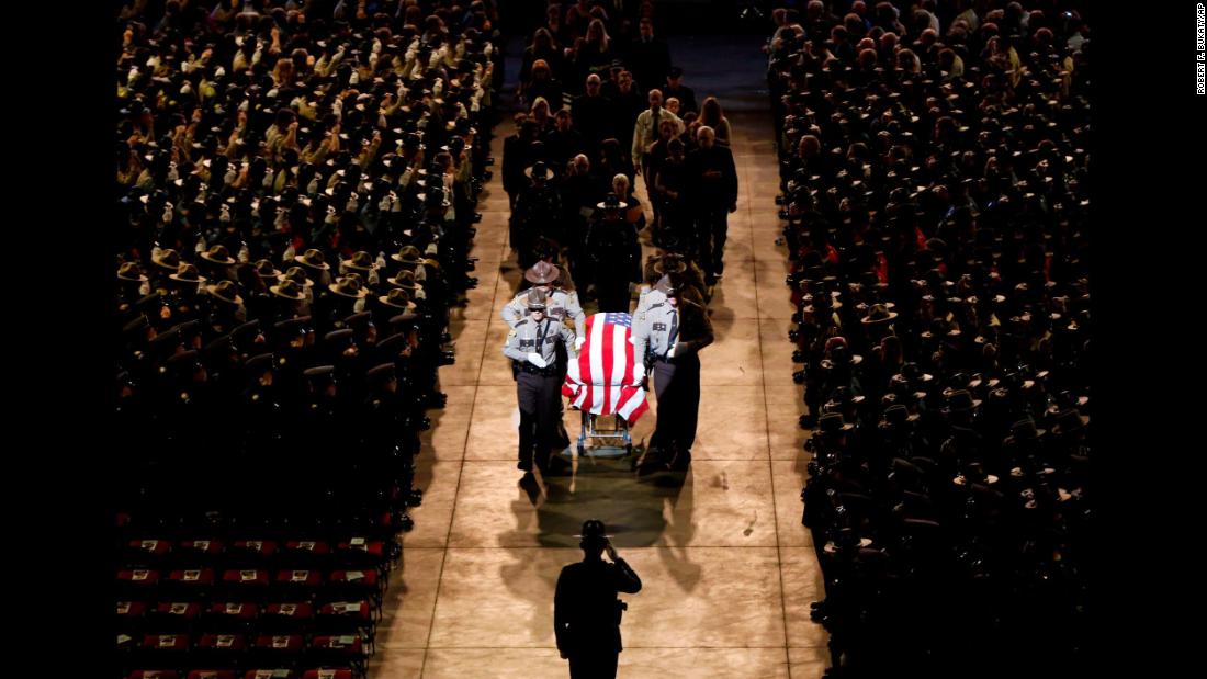 Pallbearers walk alongside the casket of Cpl. Eugene Cole at the conclusion of the sheriff&#39;s deputy funeral service in Bangor, Maine, on Monday, May 7. Cole, 61, &lt;a href=&quot;https://www.cnn.com/2018/05/01/us/maine-police-officer-wife-facebook-post/index.html&quot; target=&quot;_blank&quot;&gt;was fatally shot last month&lt;/a&gt; in the line of duty.