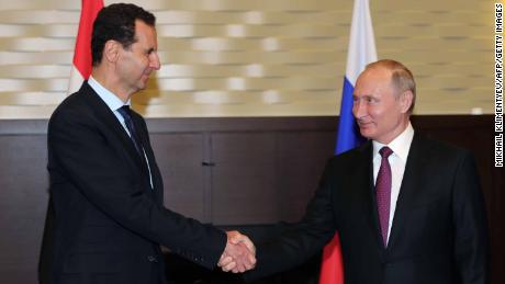 Russian President Vladimir Putin shakes hands with his Syrian counterpart Bashar al-Assad at a meeting in Sochi on May 17, 2018.