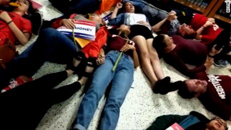 NS Slug: FL: PUBLIX DIE-IN HELD AGAINST CANDIDATE ADAM PUTNAM  Synopsis: Footage of several Marjory Stoneman Douglas students participating in a protest at a Coral Springs, FL Publix  Video Shows: - Footage of several Marjory Stoneman Douglas students participating in a protest at a Coral Springs, FL Publix by drawing chalk outlines in the parking lot and lied down for exactly 12 minutes in the store. - MSD student David Hogg called for a boycott of Publix due to them donating to gubernatorial candidate Adam Putnam, who has an &quot;A&quot; rating from the NRA.   Keywords: FLORIDA PUBLIX PROTEST NRA GUN SUPPORT