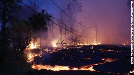 Lava from a Kilauea volcano fissure moves up a residential street in Leilani Estates.