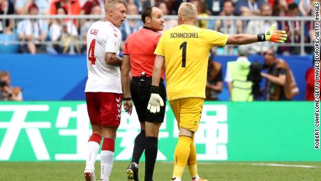 Denmark&#39;s Simon Kjaer and Kasper Schmeichel confront referee Antonio Mateu after the penalty award.