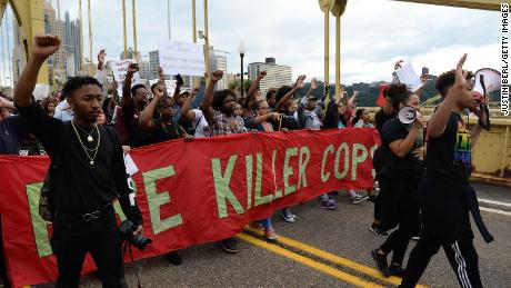 A car crosses the crowd to protest the killing by the Antwon Rose police in Pittsburgh 