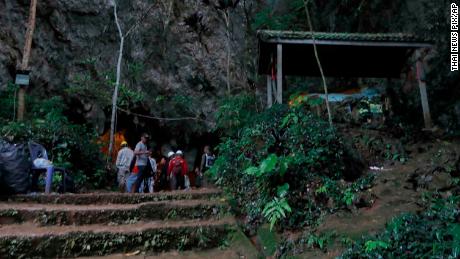   Rescue teams gather at the entrance to the deep cave where the team disappeared. 