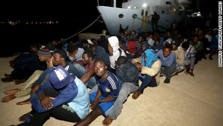   Migrants wait at a naval base in Tripoli, Libya. after being rescued in the Mediterranean this week 