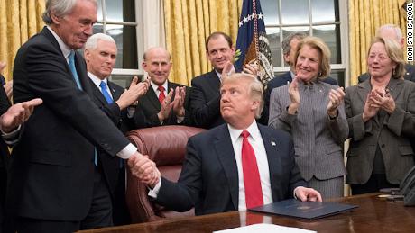 US President Donald Trump shakes hands with US Senator Ed Markey after signing a bill to prevent the entry of opioids into the United States on January 10, 2018.