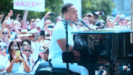   John Legend performs for thousands at the rally in Los Angeles. 