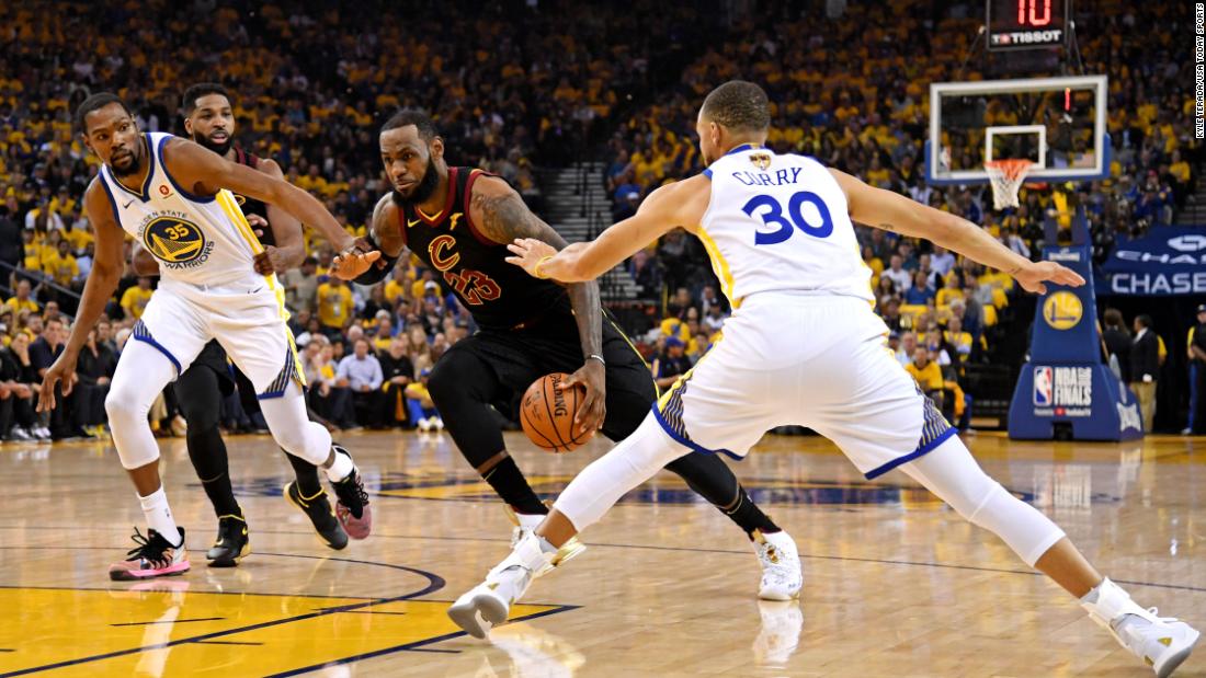 James drives to the basket against Golden State Warriors guard Stephen Curry and forward Kevin Durant during the first quarter of Game 1 of the 2018 NBA Finals.