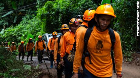   Men from the Department of Disaster Prevention and Mitigation arrive at the cave entrance on July 6 in Chiang Rai, Thailand. 