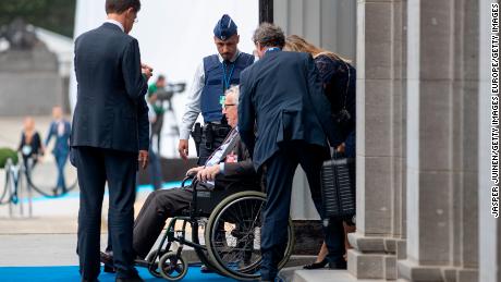 Jean-Claude Juncker is seen seated in a wheelchair as he enters the building where Wednesday evening&#39;s NATO dinner was held.