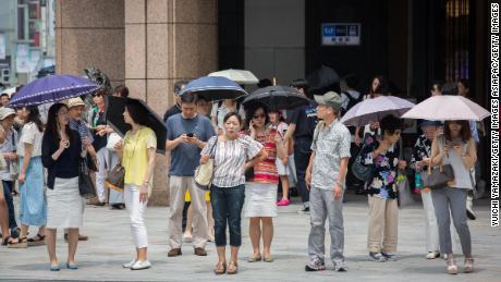   People use umbrellas to escape the heat on July 22, 2018 in Ginza Tokyo, Japan. Japan. 