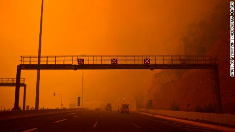   The sky of the Greeks blushes over a roadblock on the road to Kineta, near Athens. 