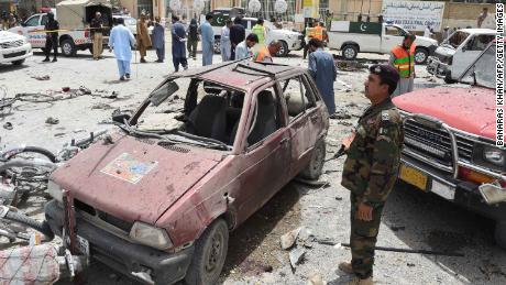   Pakistani volunteers and security agents visit the site of the bombing Wednesday in Quetta.
