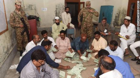   Pakistani soldiers stand guard on Wednesday as election officials count votes in a Lahore polling station. He added that the results also indicated real support for Khan: 