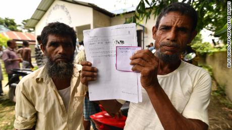   A resident holds documents on his way to check his name on the final list of the National Register of Citizens (NRC) in the village of Kuranibori, in the district of Morigoan of Assam on July 30, 2018. 