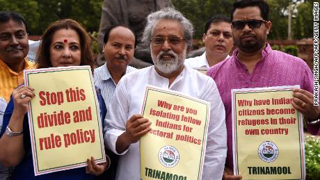   Indian lawmakers waving placards to protest against the national register of citizens of Assam. Parliament in New Delhi July 31, 2018. 