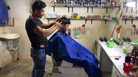 Abdulkadir Halit opened a barber shop in the Rahme Cluster after his shop in Hama was destroyed in airstrikes. He cuts about six heads of hair per day at a cost of 200 Syrian pounds ($2). 