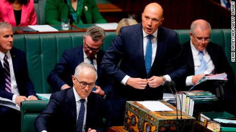 Australia&#39;s Minister for Home Affairs Peter Dutton (2nd R) speaks at Parliament as Australian Prime Minister Malcolm Turnbull (bottom L) looks at his notes in Canberra on August 20, 2018. 