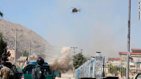 An MD 530F military helicopter targets a house where suspected attackers are hiding in Kabul, Afghanistan, Tuesday, Aug. 21, 2018.