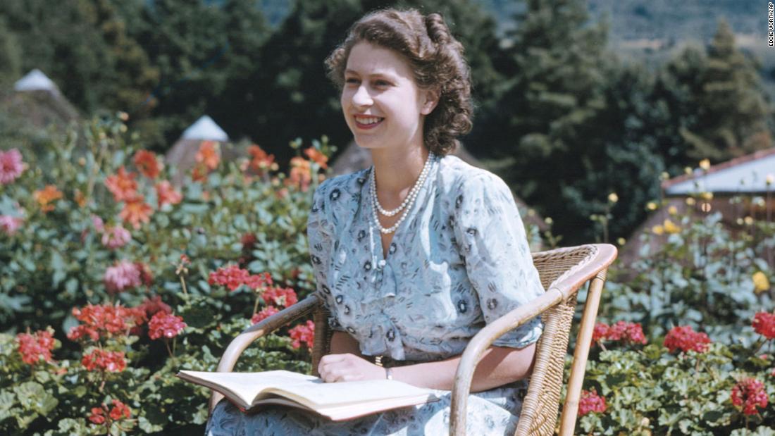 With the Drakensberg Mountains behind her, Princess Elizabeth sits in South Africa&#39;s Natal National Park on April 21, 1947. 마가렛 공주는 약 여름 드레스를 입는다..
