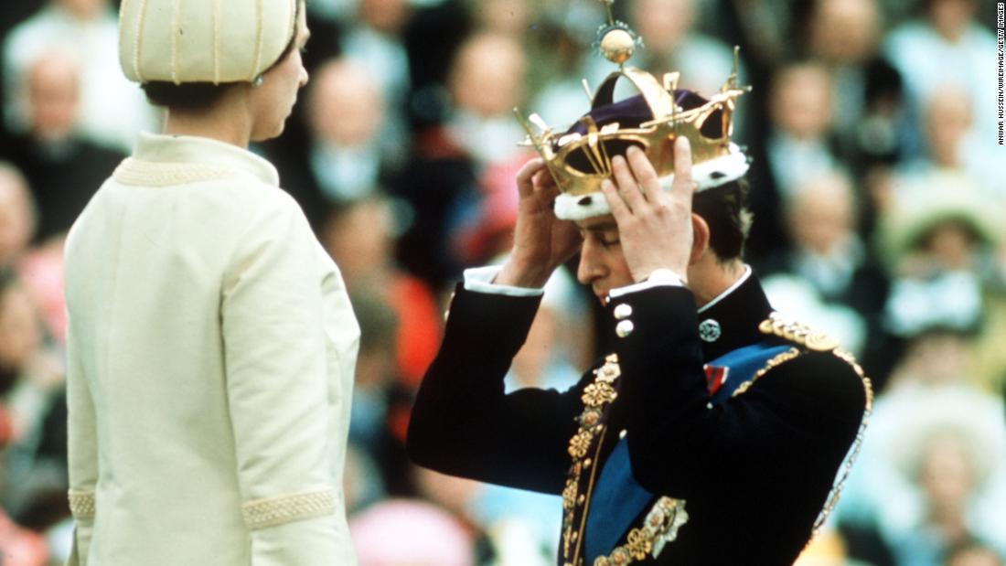 Prince Charles adjusts his coronet during his investiture ceremony as Prince of Wales in 1969.