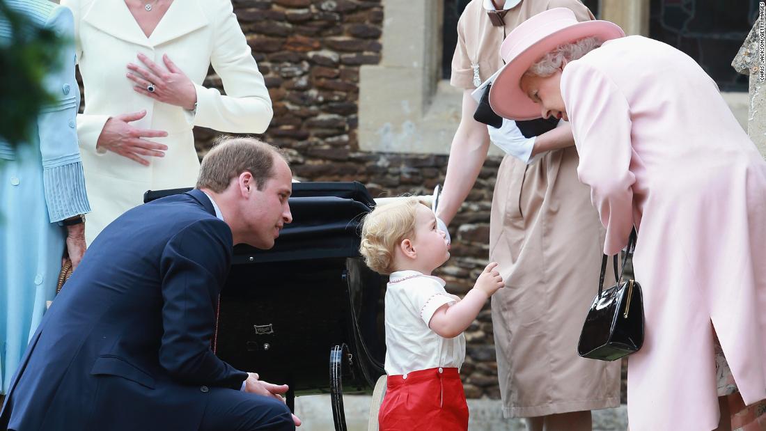 Elizabeth listens to her great-grandson, 프린스 조지, outside a church where George&#찰스 왕세자가 어머니에게 키스하다ter, 샬럿, was being christened in July 2015. George and Charlotte are the children of Prince William, 왼쪽7월에 세례를 받았다.ne.