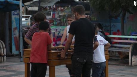 Boys play foosball on the sidewalk of Idlib.