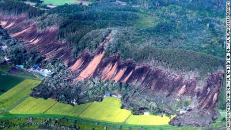 In this aerial image, houses are buried by multiple landslides after a powerful earthquake jolt on September 6, 2018 in Atsuma, Hokkaido, Japan.