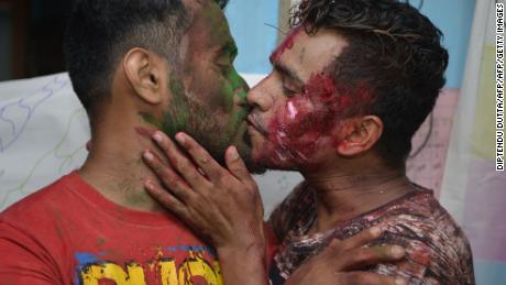 Two men embrace while members of the LGBT community celebrate the Supreme Court's decision. 