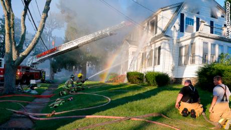 Firefighters fight a fire in the home on Thursday in North Andover, Massachusetts.