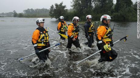 Members of the FEMA Task Force 4 for Urban Search and Rescue in Oakland, California, search for evacuees in a flooded area during Hurricane Florence on September 14, 2018 in Fairfield Harbor , North Carolina.