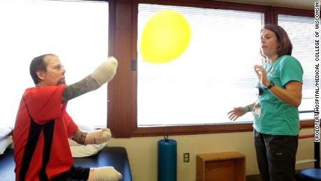 Physiotherapist Cheryl Vorwald helps Greg Manteufel in his rehabilitation at Froedtert Hospital.