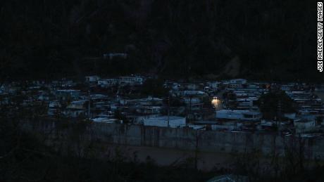 Car lights are seen in a helpless neighborhood of Utuado, three weeks after the hurricane.