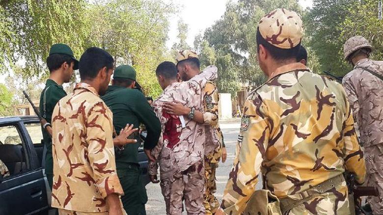 A soldier injured in the attack is treated at the scene in the southern Iranian city of Ahvaz.