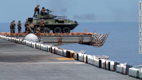 US Marines aboard a light armored vehicle on the cockpit aboard the amphibious assault ship, USS Wasp guns, en route into the South China Sea on September 27, 2018.