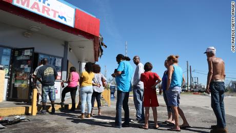 People queuing Friday in front of a convenience store in Panama City in the wake of Hurricane Michael.