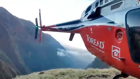 A helicopter lands close to a storm site Saturday after searching for missing climbers on Mt. Gurja. 