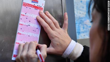 A woman fills a Mega Millions lottery ticket in New York on Friday. 