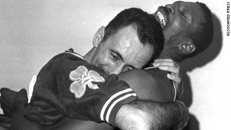 FILE -- Boston Celtics stars Bill Russell, right, and Bob Cousy hug after defeating the Los Angeles Lakers for their fifth consecutive NBA Championship, in Los Angeles, in this April 25, 1963 photo.On Wednesday night, May 26, 1999, the team Celtics finally honor Russell publicly when it rededicates his No. 6 alongside the 11 NBA championship banners Russell helped win. (AP Photo/File)