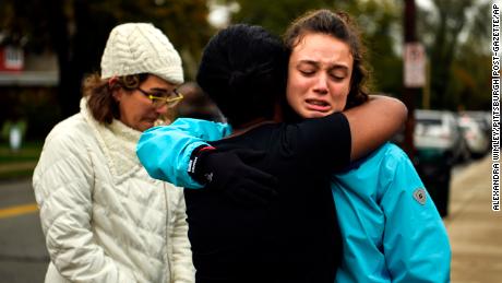 Kate Rothstein, left, watches Tammy Hepps hug Simone Rothstein, 16, after several people were shot dead at The Tree of Life synagogue in Pittsburgh.